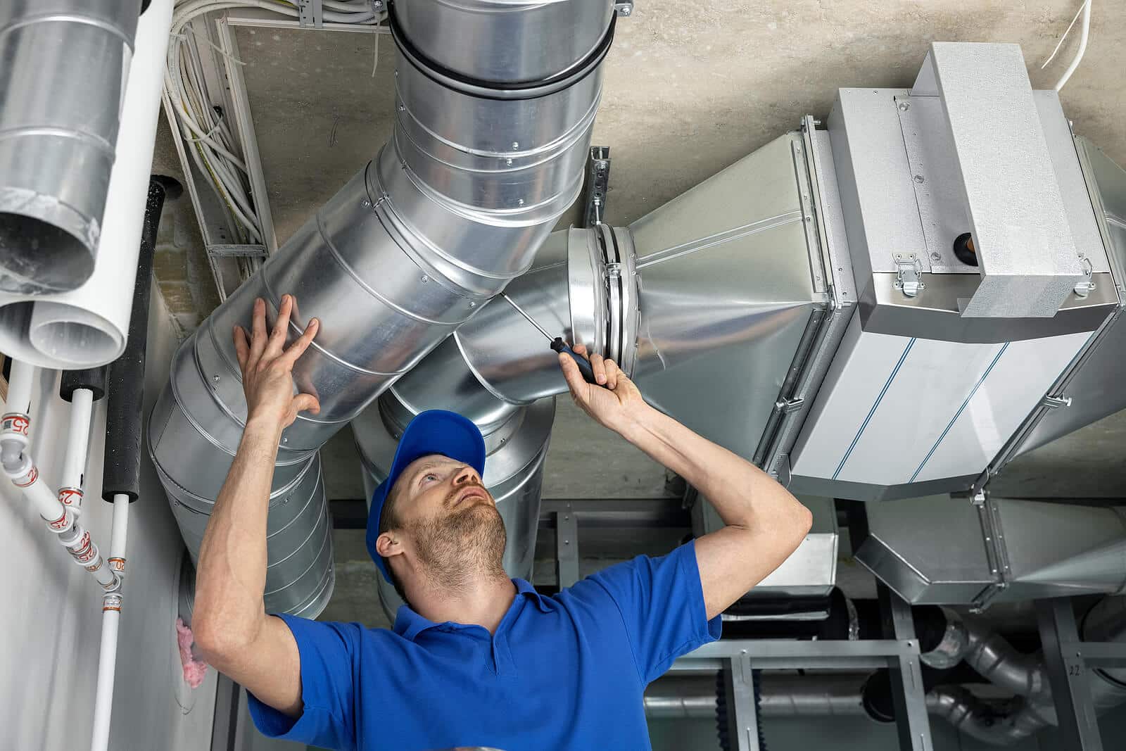 HVAC technician inspecting and repairing air ducts in Glendora