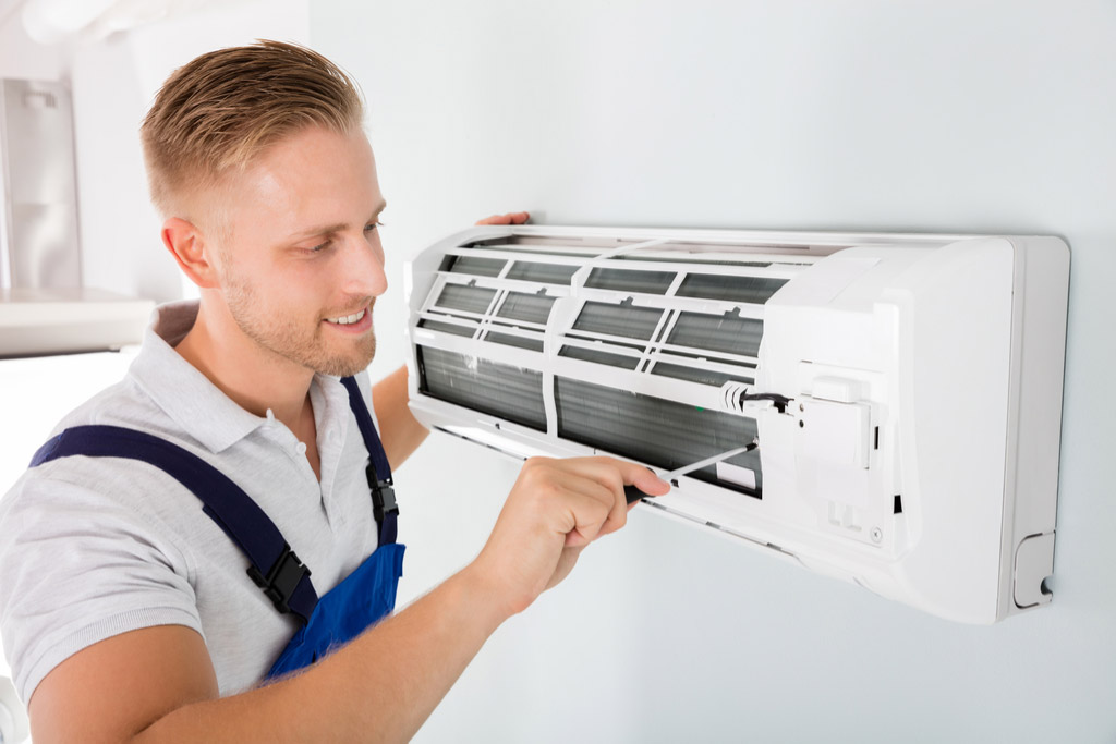 HVAC technician maintaining a ductless air conditioner in Glendora
