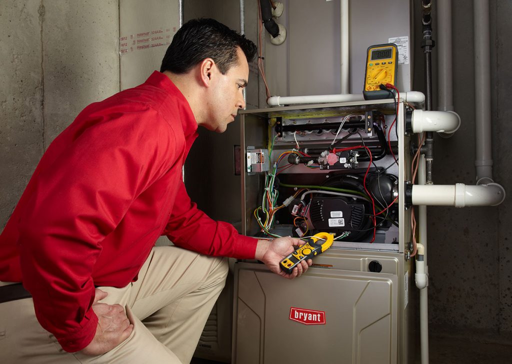 Heating technician diagnosing a furnace repair in Glendora