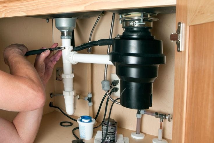 Plumber repairing a garbage disposal in Glendora